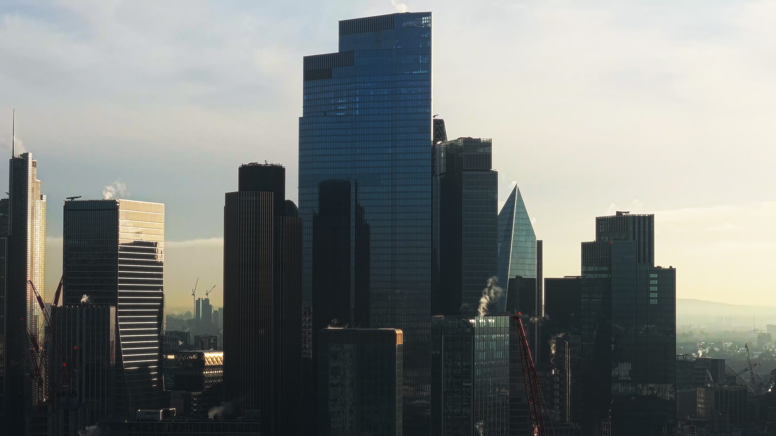 Aerial of the City of London towers in low golden light