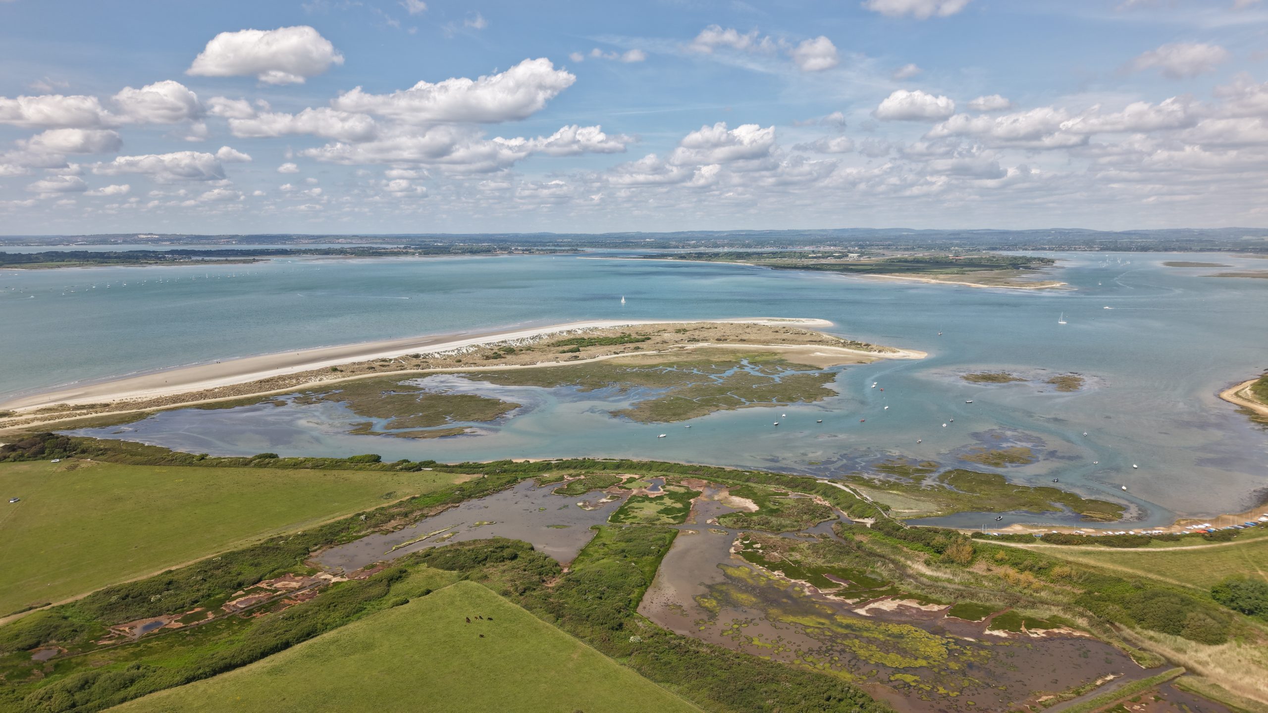 High aerial over East Head and Chichester Harbour at West Wittering, sandspit and saltmarsh below