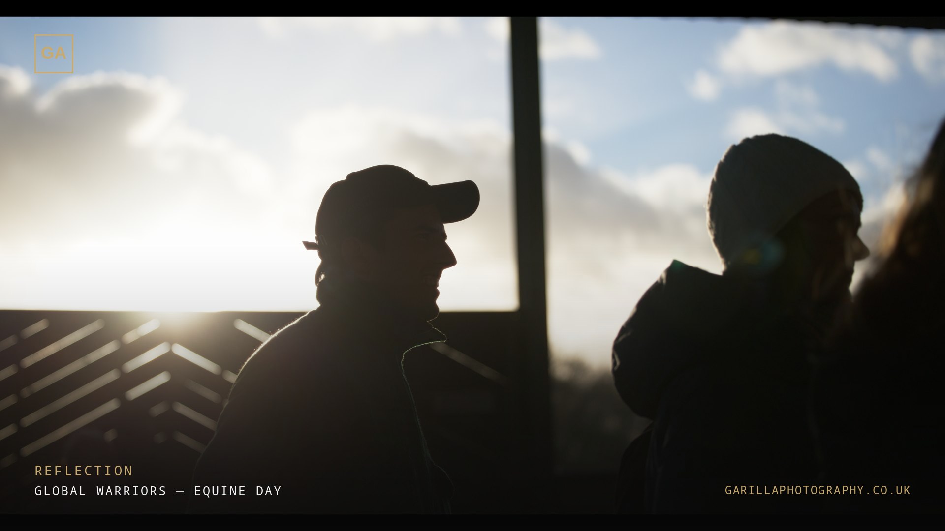 Two figures silhouetted against a bright winter sky — a still from the film, titled Reflection
