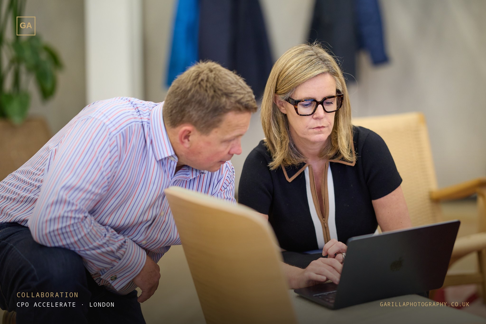Two delegates working together over a laptop — titled Collaboration