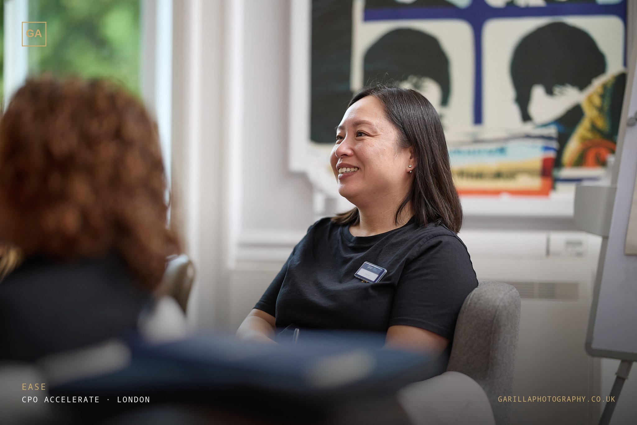 A delegate laughing during a session — titled Ease