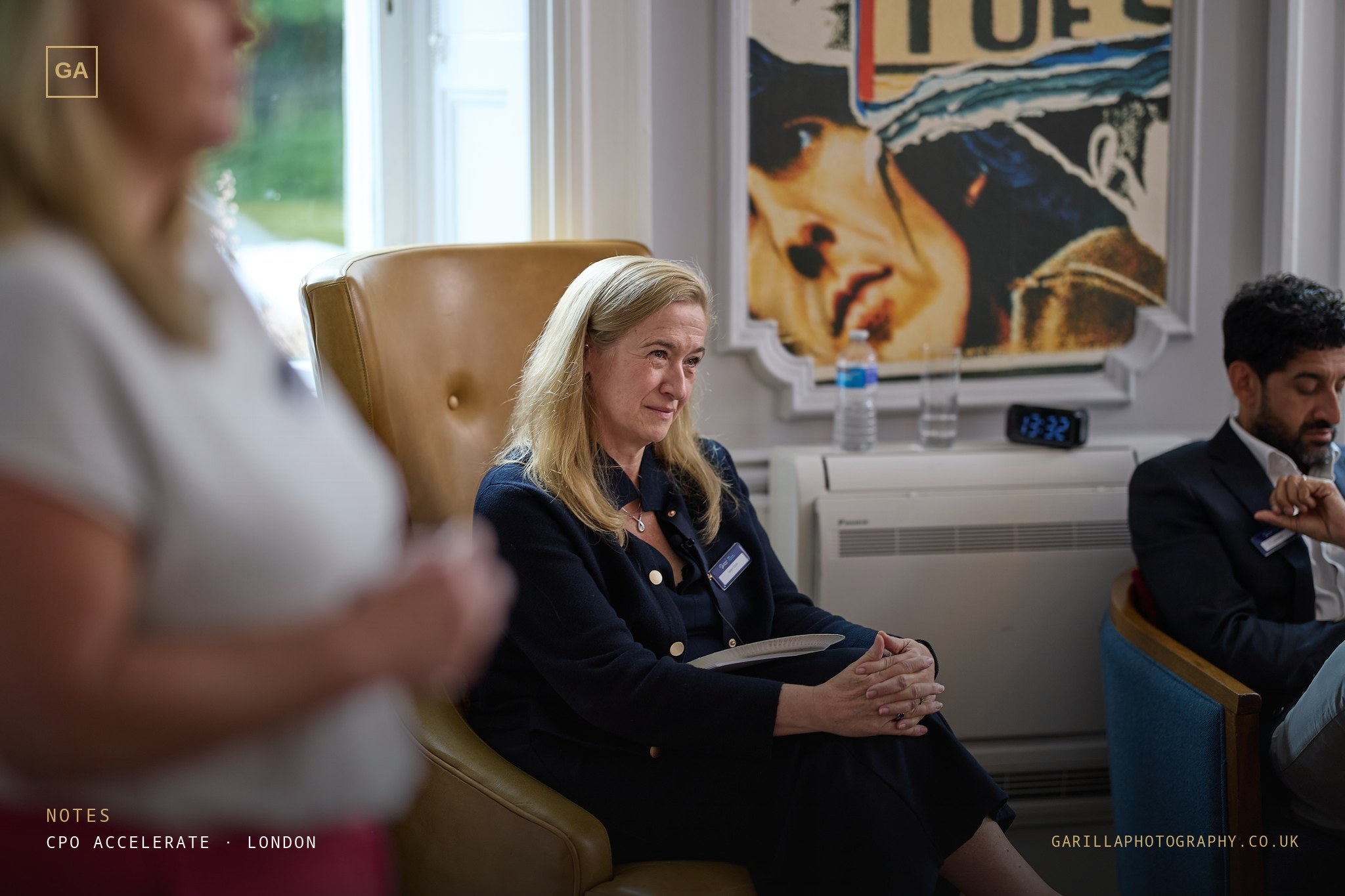 A delegate listening from a leather armchair — titled Notes