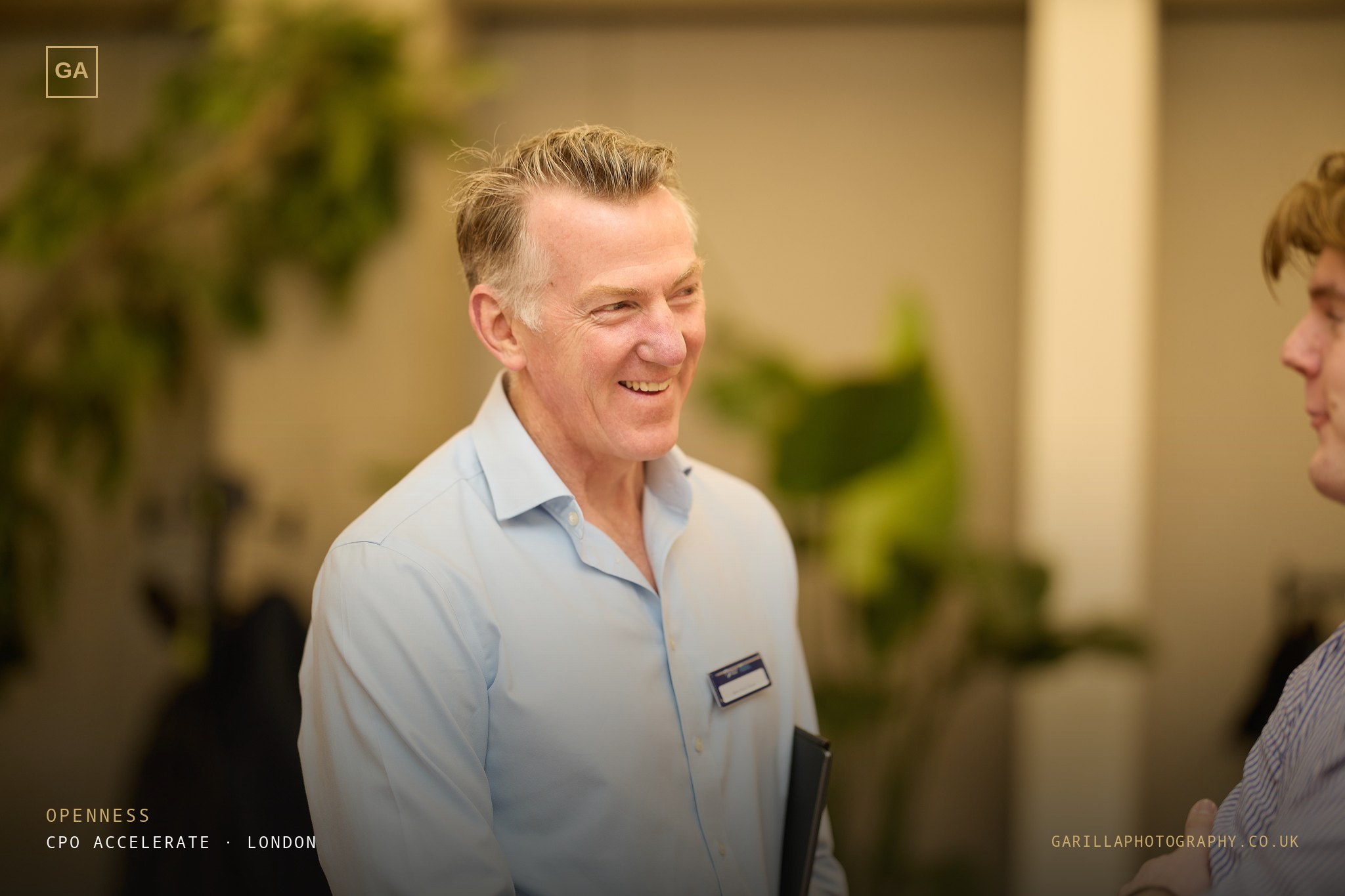 A delegate smiling in conversation — titled Openness