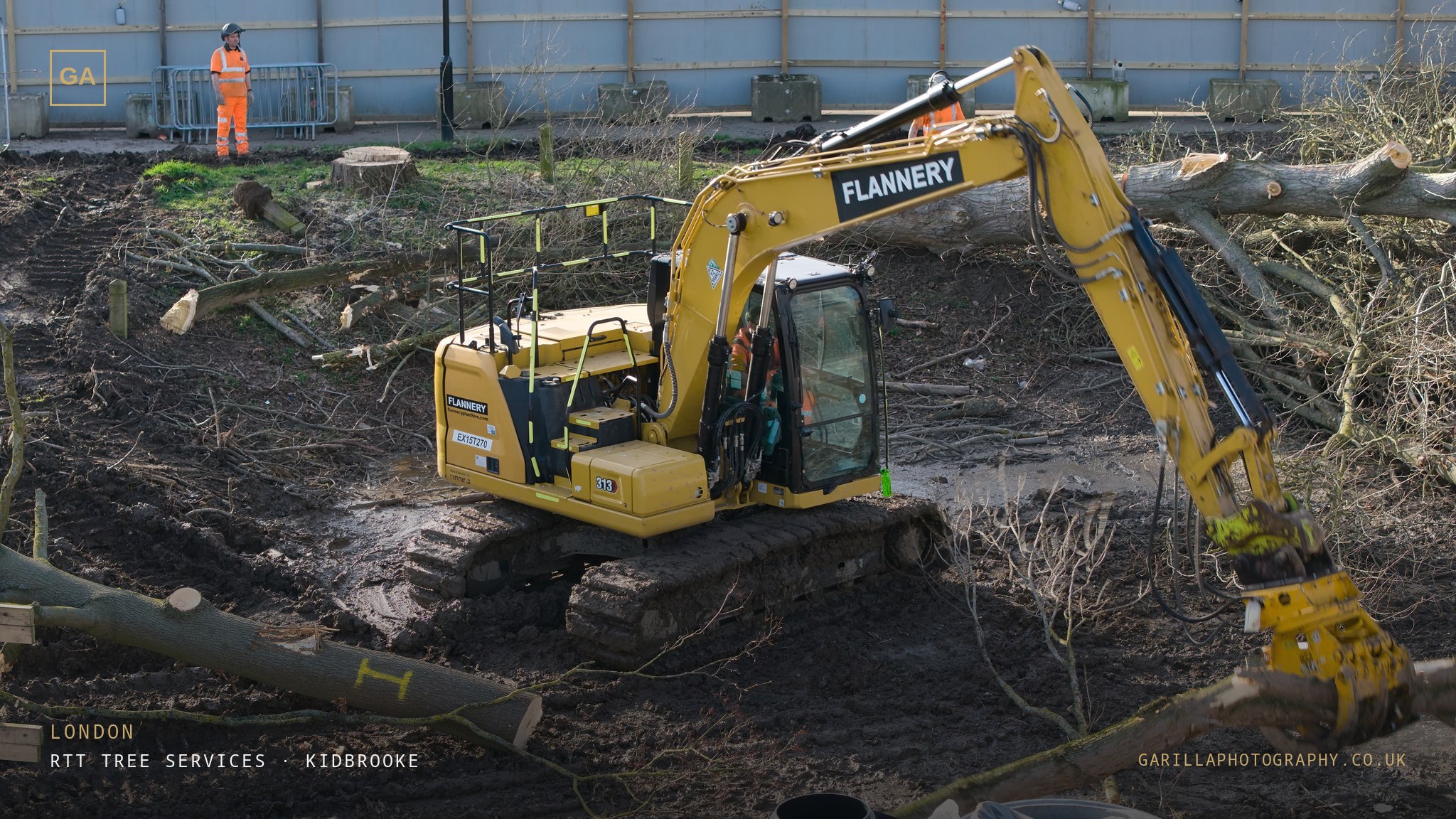 An excavator working amid felled trees on the cleared plot — titled London